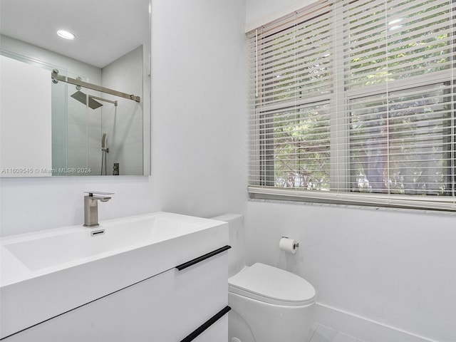 bathroom with vanity, toilet, and tile floors