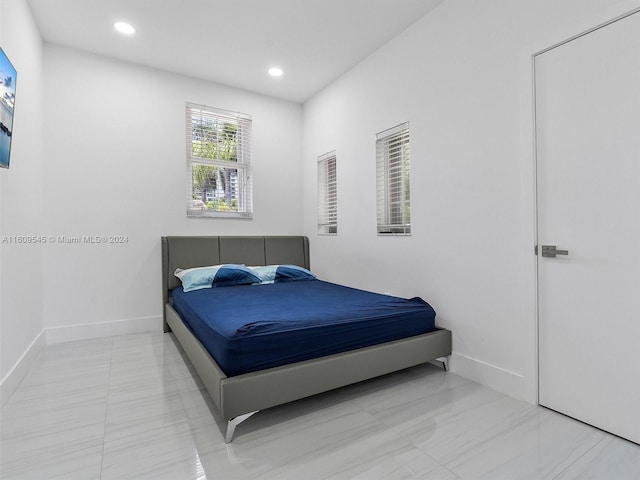 bedroom with light tile floors