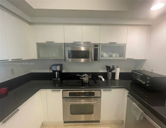 kitchen with white cabinetry and appliances with stainless steel finishes