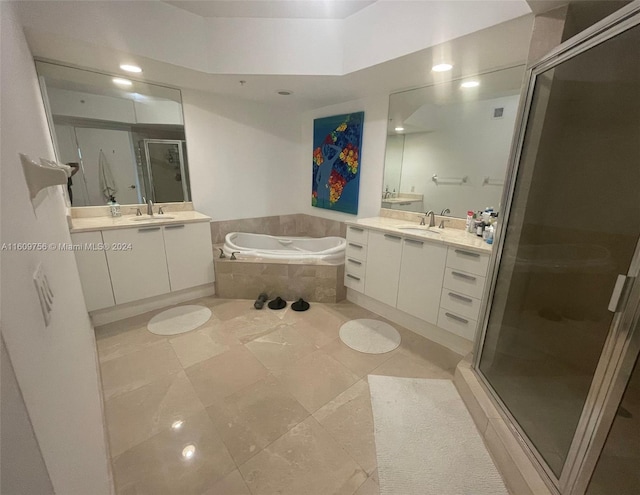 bathroom with tile patterned flooring, vanity, and plus walk in shower