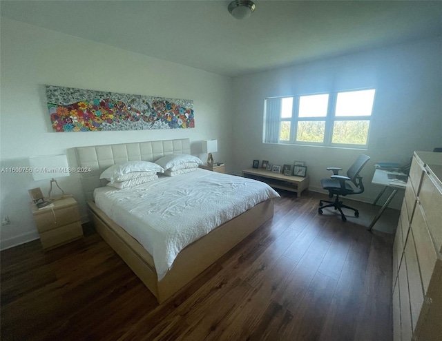 bedroom with dark wood-type flooring