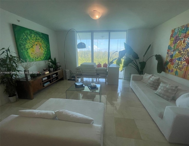 living room with light tile patterned floors and floor to ceiling windows