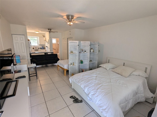 bedroom featuring ceiling fan and light tile floors