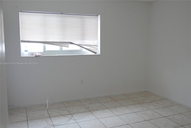 spare room featuring light tile flooring