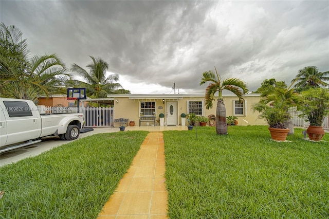 ranch-style home with a front lawn