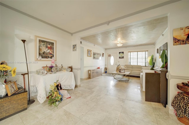 living room with tile flooring and crown molding