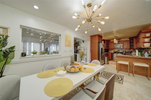 dining space featuring an inviting chandelier and light tile floors