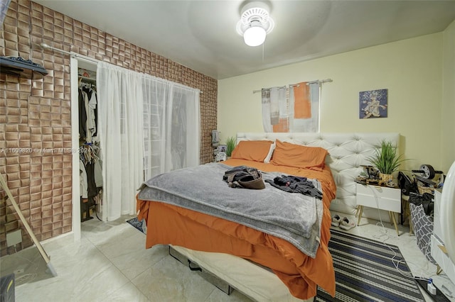 tiled bedroom with a closet and ceiling fan