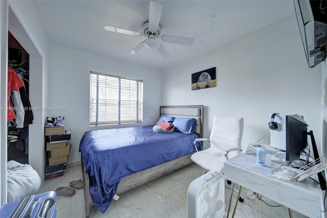 tiled bedroom featuring ceiling fan