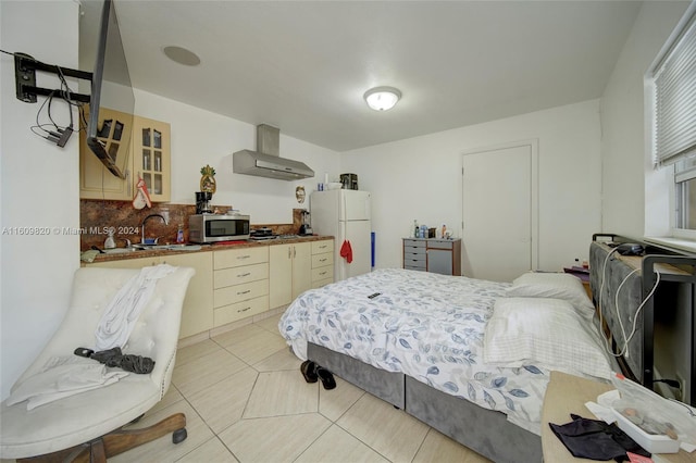 tiled bedroom featuring white refrigerator and sink