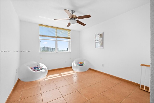 bedroom with ceiling fan and tile patterned flooring