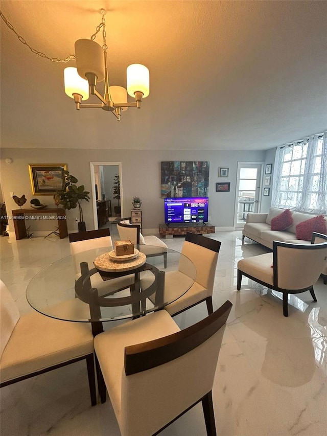 dining area featuring a notable chandelier