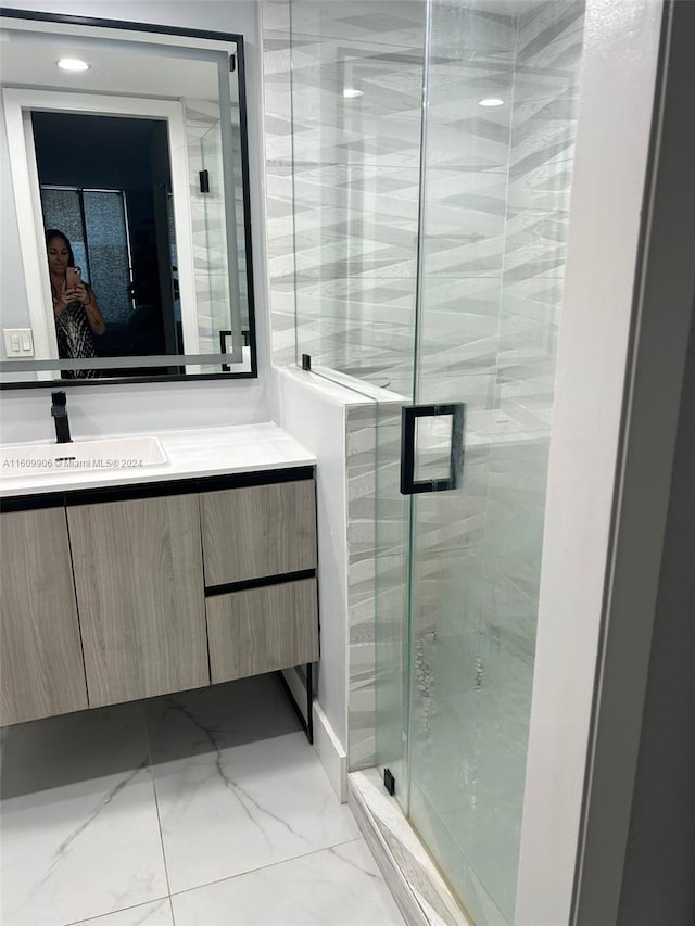 bathroom with vanity and an enclosed shower