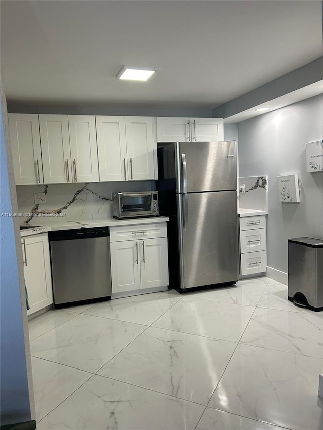 kitchen featuring appliances with stainless steel finishes and white cabinetry