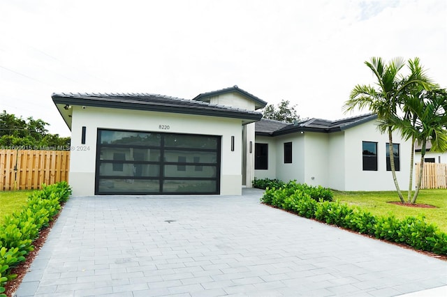 view of front of property with a front yard and a garage