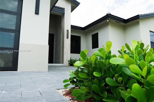 view of exterior entry featuring a patio area