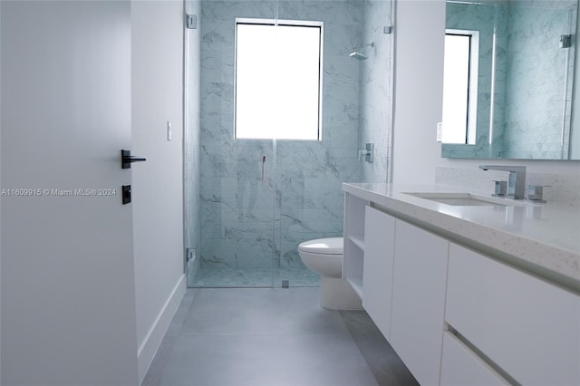 bathroom featuring vanity, toilet, and an enclosed shower