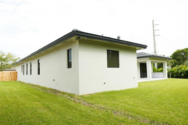 view of property exterior with a lawn