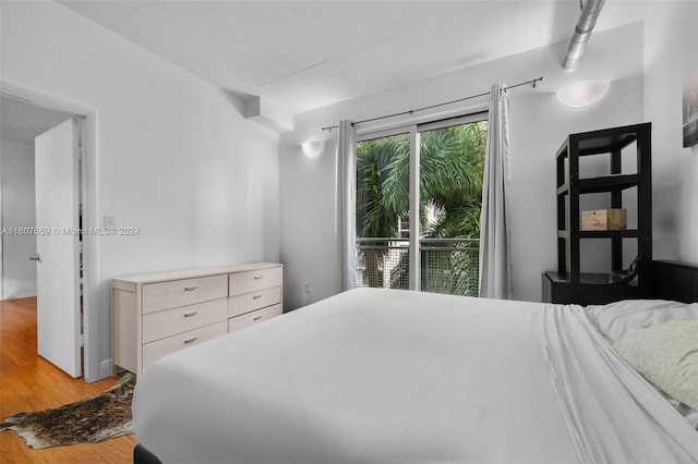 bedroom featuring light hardwood / wood-style flooring and access to outside