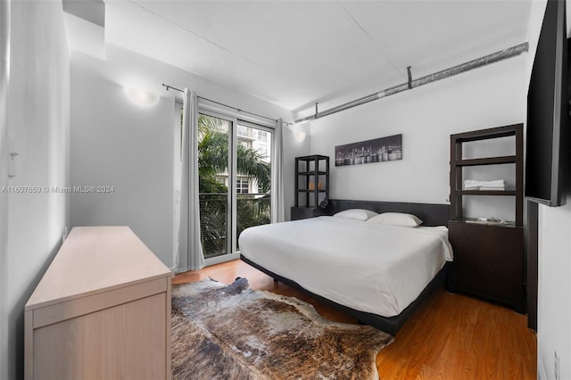 bedroom featuring access to outside and wood-type flooring