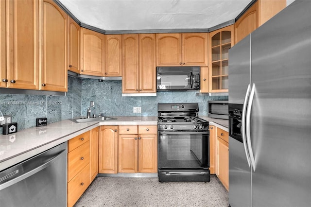 kitchen featuring tasteful backsplash, sink, and black appliances