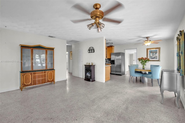 unfurnished living room featuring ceiling fan