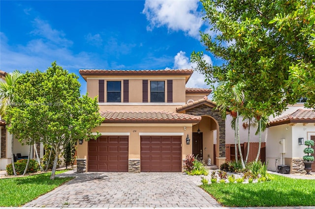 mediterranean / spanish-style home with a garage