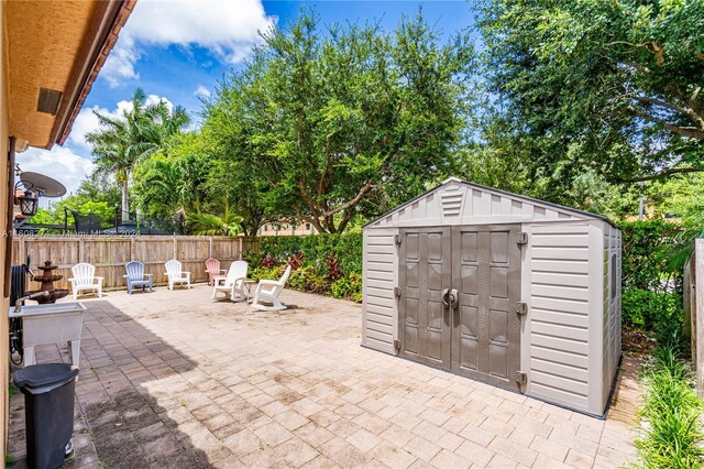 view of terrace with a shed