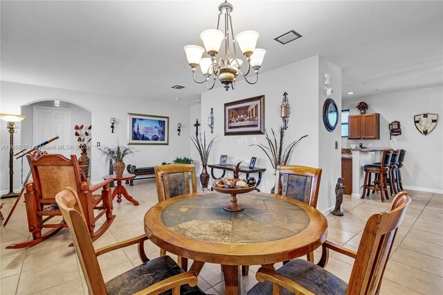 dining area with light tile flooring and a chandelier