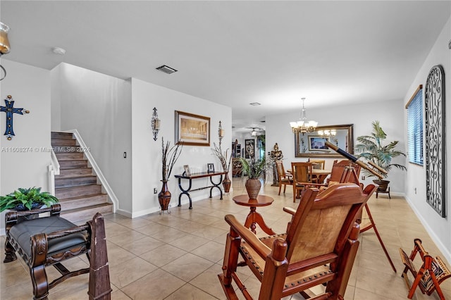 living room with a notable chandelier and light tile floors