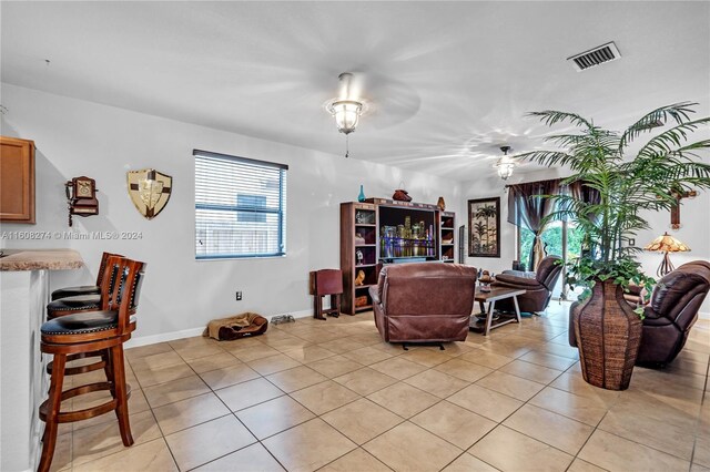 living room featuring ceiling fan and light tile floors