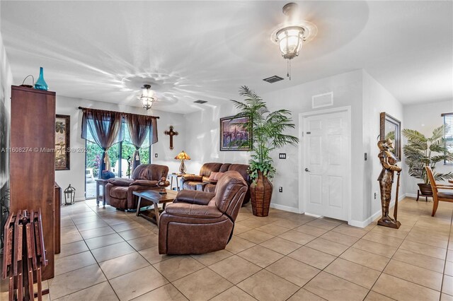 living room with light tile flooring and ceiling fan