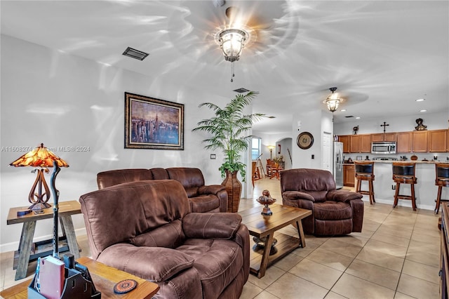 tiled living room featuring ceiling fan