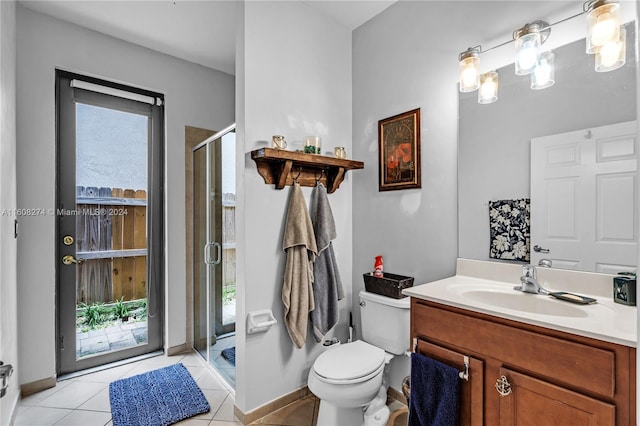 bathroom featuring a shower with shower door, tile flooring, oversized vanity, and toilet