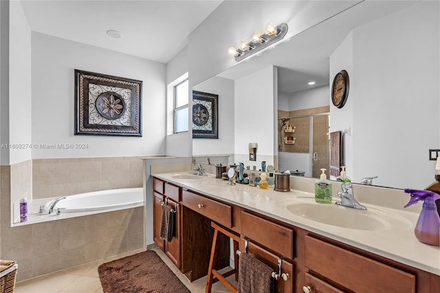 bathroom featuring vanity with extensive cabinet space, dual sinks, tile floors, and plus walk in shower