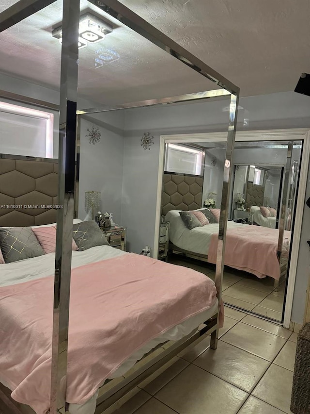 bedroom with light tile patterned floors