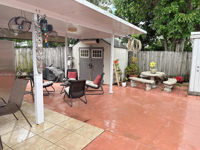 view of patio with an outbuilding, a shed, area for grilling, and a fenced backyard