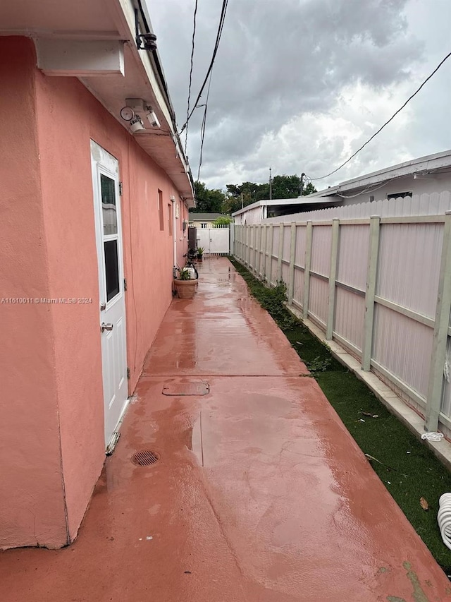 view of property exterior with fence and stucco siding