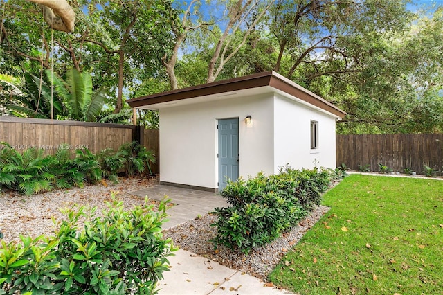 view of outdoor structure with a lawn