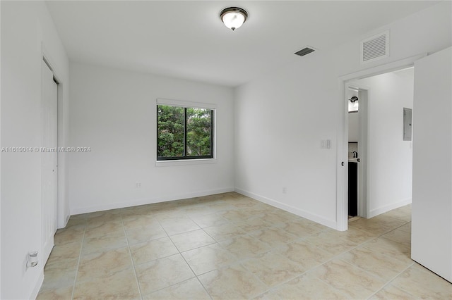 tiled empty room with electric panel