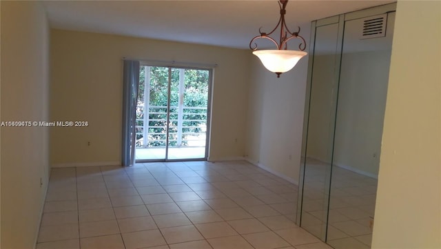 unfurnished room with visible vents, baseboards, and light tile patterned floors