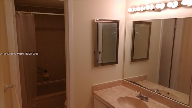 bathroom featuring toilet, shower / tub combo with curtain, and vanity