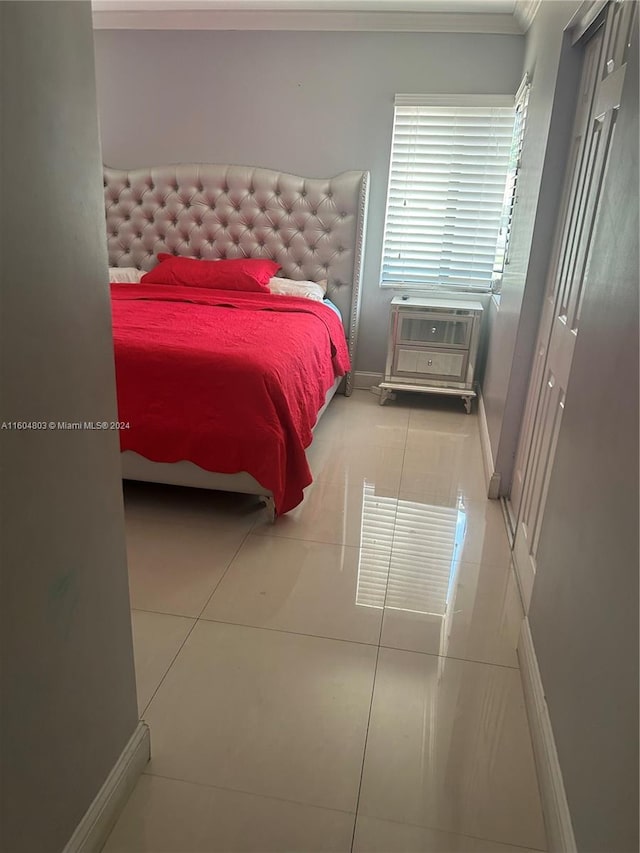 tiled bedroom with ornamental molding