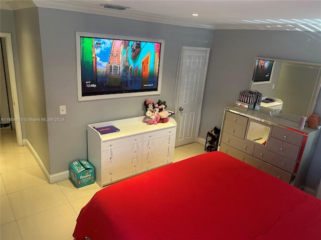 bedroom with light tile patterned floors and ornamental molding