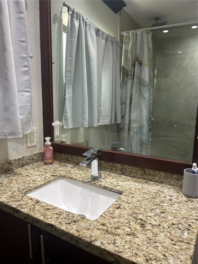 bathroom with vanity and curtained shower