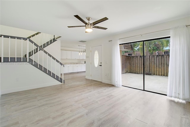 foyer entrance featuring ceiling fan and light hardwood / wood-style flooring