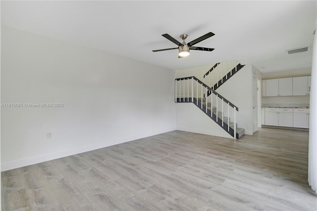 unfurnished living room with ceiling fan and light wood-type flooring