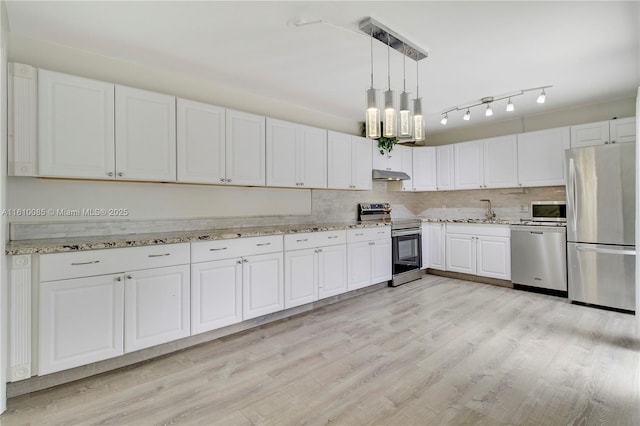 kitchen featuring white cabinets, decorative light fixtures, light hardwood / wood-style floors, and appliances with stainless steel finishes