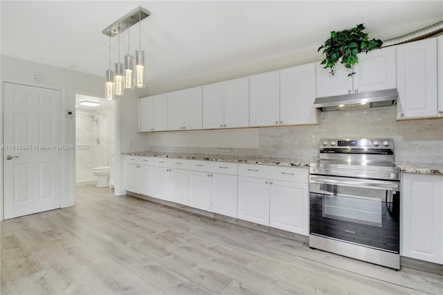 kitchen featuring light stone countertops, pendant lighting, light hardwood / wood-style floors, stainless steel electric stove, and white cabinets