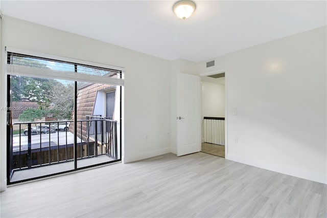 spare room featuring light wood-type flooring